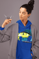 Blue cropped women's hoodie featuring a bold eye design and empowering text, styled under a gray coat. Flattering eco hoodie for everyday wear.