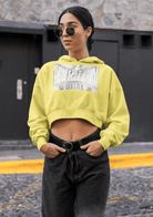 Eco hoodie in bright yellow for women, cropped fit with bold chest print, ideal for sustainable streetwear style and breathable comfort.