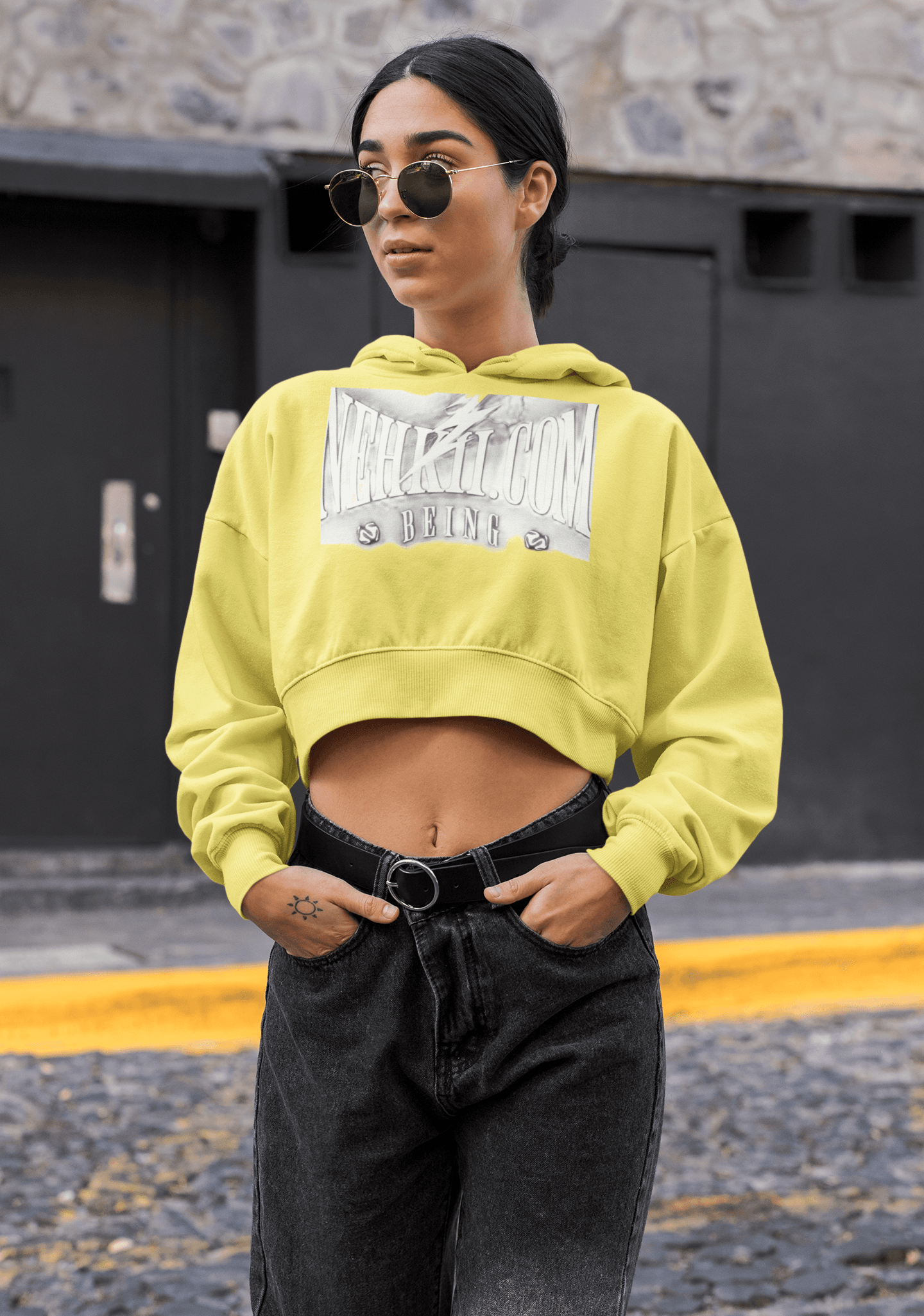 Eco hoodie in bright yellow for women, cropped fit with bold chest print, ideal for sustainable streetwear style and breathable comfort.