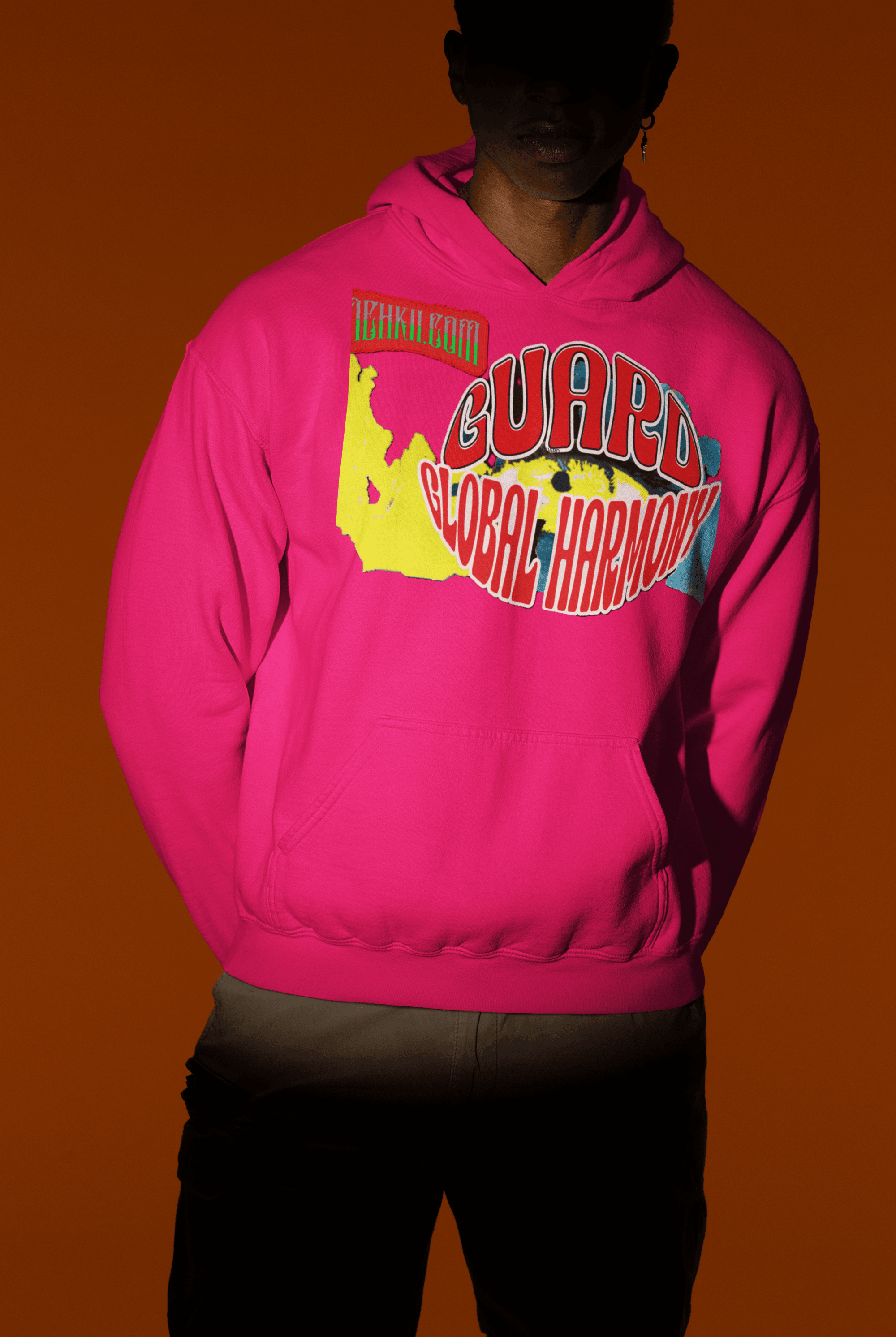 Hot pink sustainable women’s crop hoodie in cotton with bold 'Guard Global Harmony' artwork, stylish ethical streetwear option.