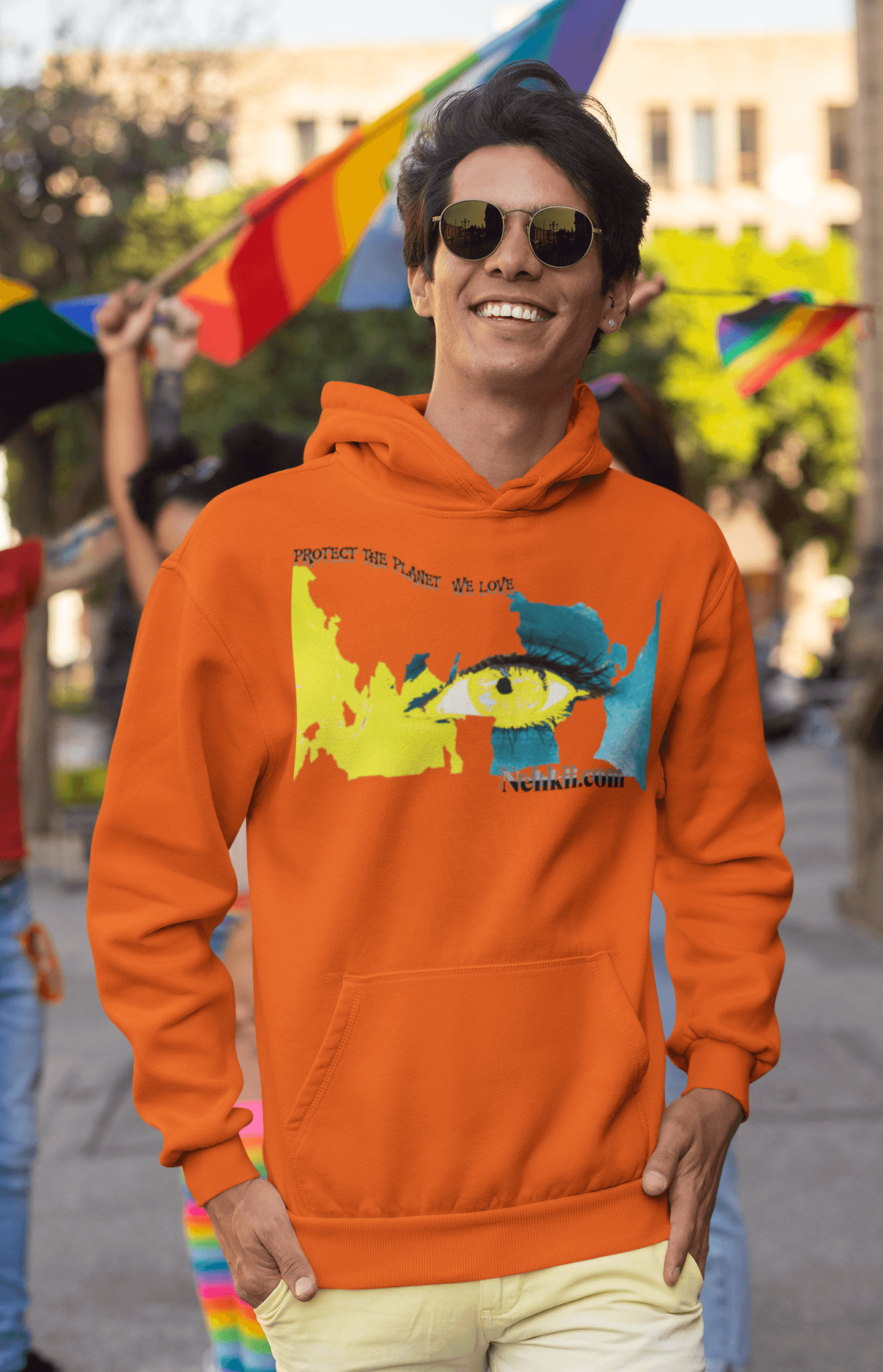 Soft eco-friendly cotton hoodie in vibrant orange with artistic eye and earth graphic, promoting sustainable fashion for men’s streetwear.