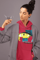 Red cropped women's hoodie showcasing a colorful eye graphic and empowerment theme, styled with a gray overcoat. Trendy and eco-friendly apparel.