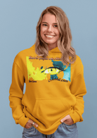 Women’s Prove Strong Hoodie in mustard yellow featuring artistic eye design and motivational quote. Cozy apparel for confident expression.